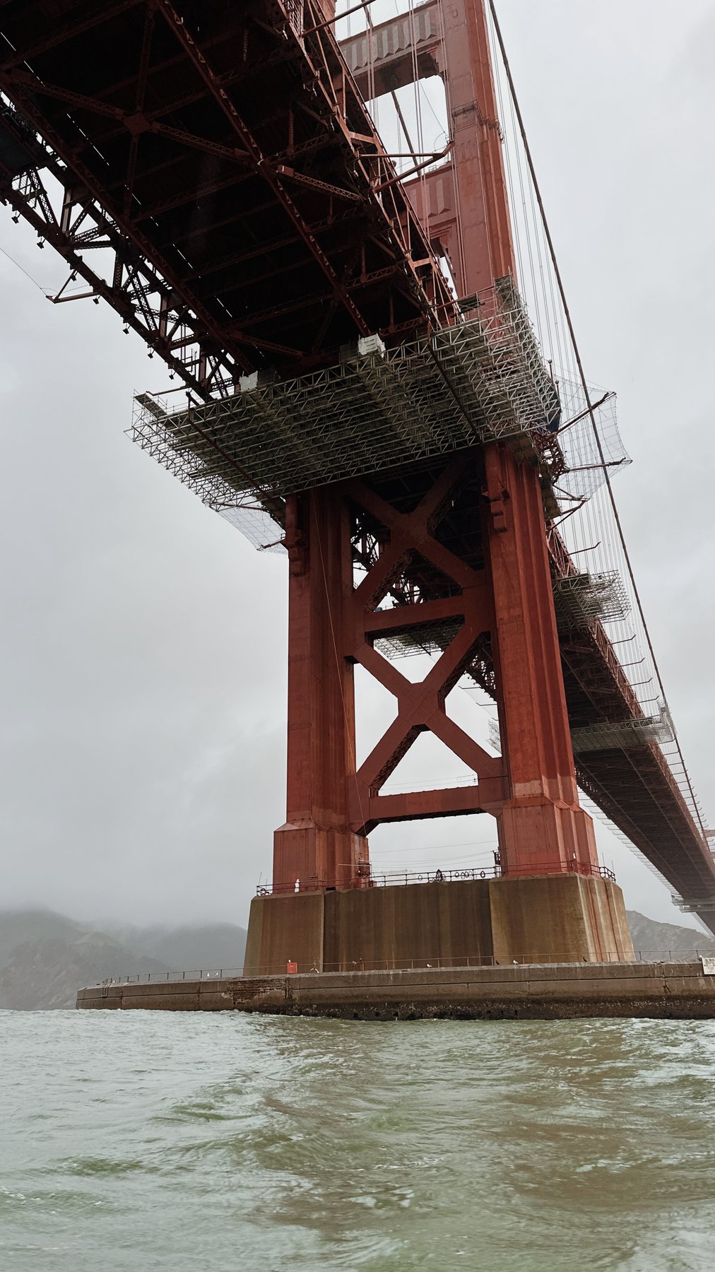 the underside of the golden gate bridge, red steel close up