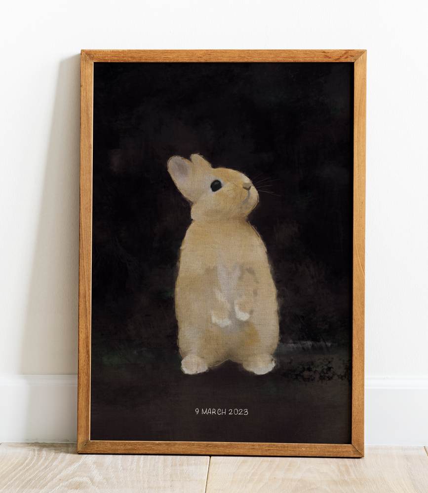 framed print of the rabbit portrait leaning against a white wall