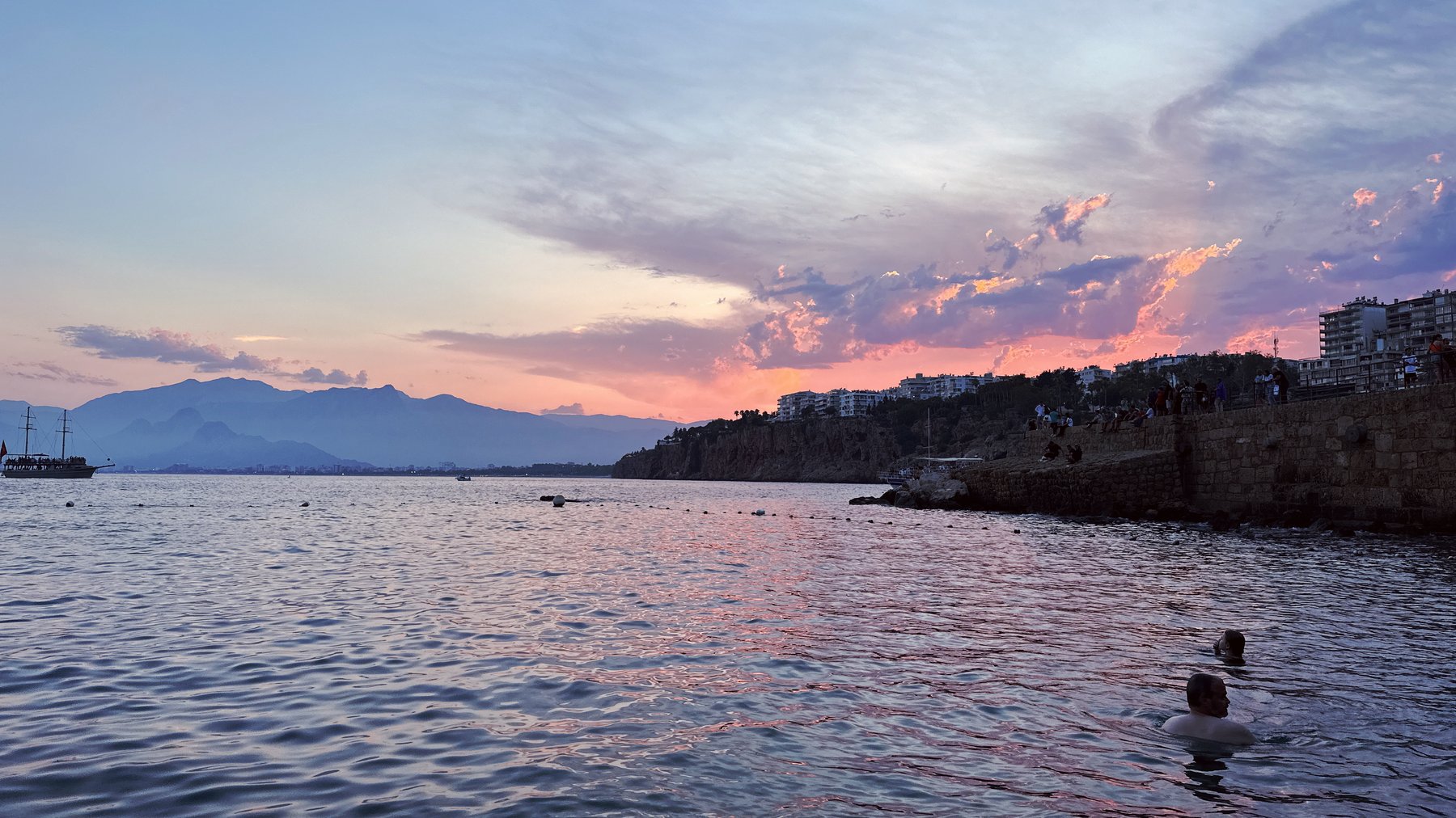 a swimmer heading into a colorful sunset