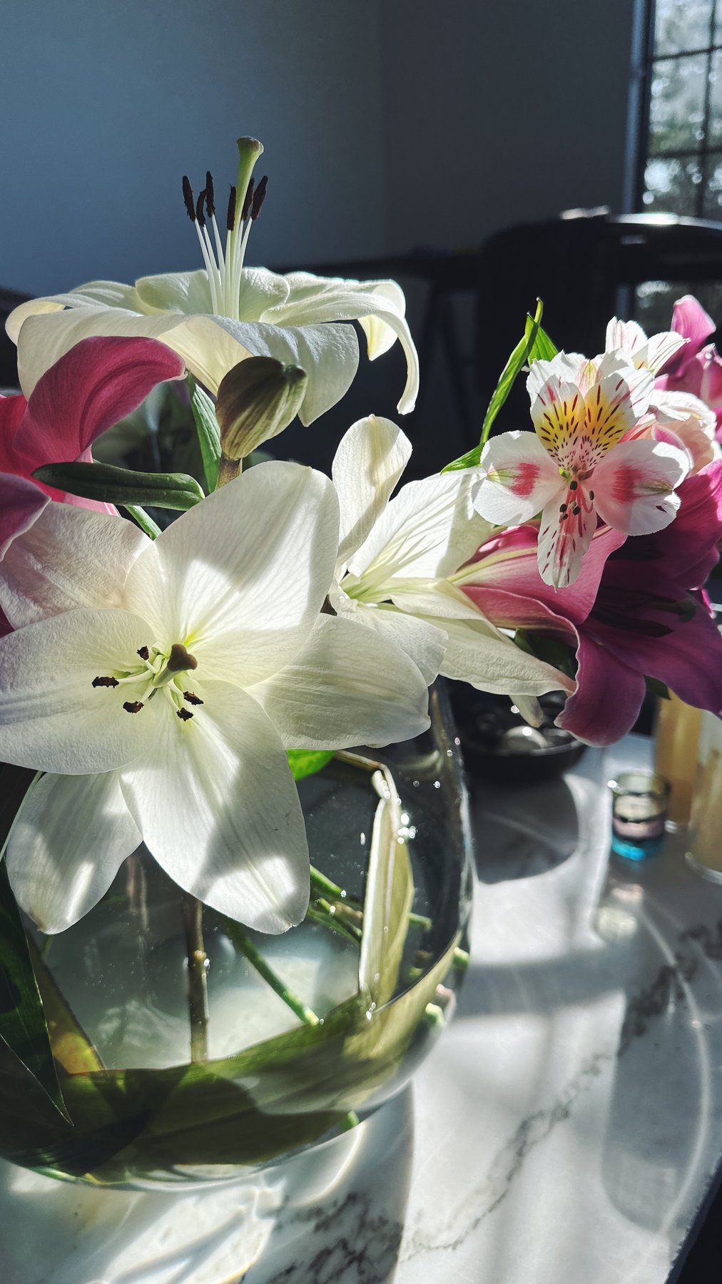 a bouquet of white lilies by a window