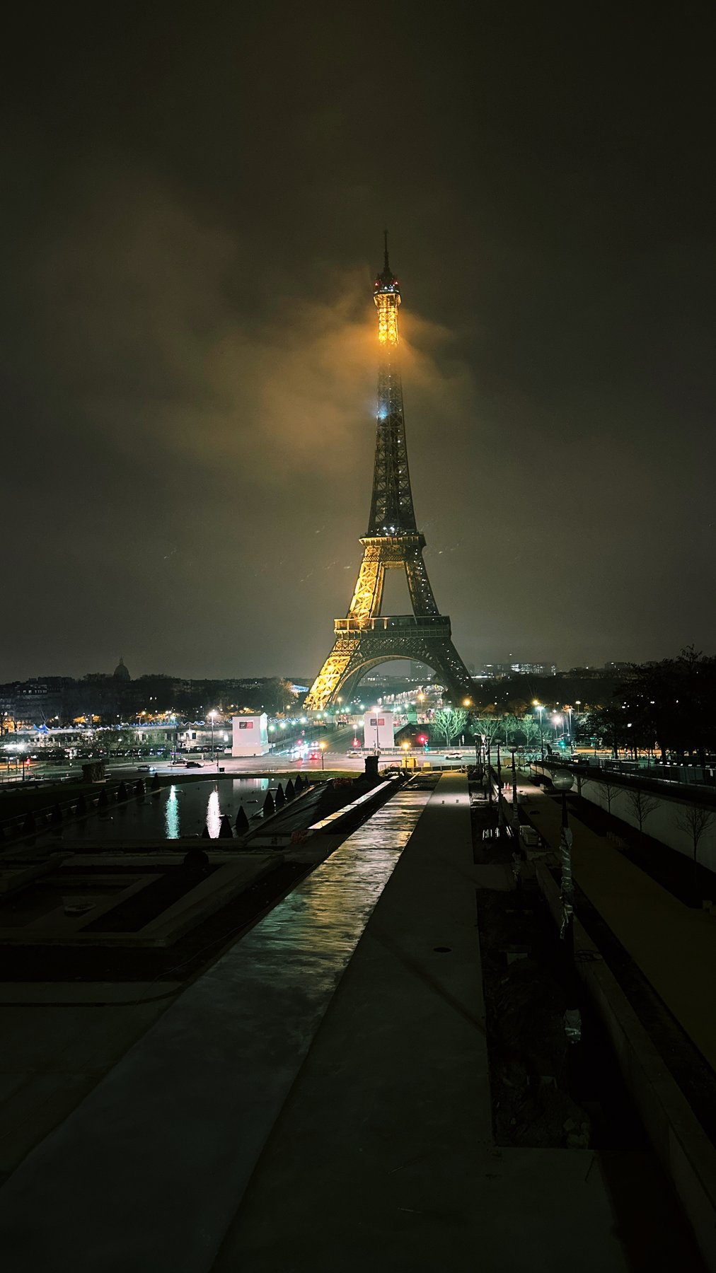 the eiffel tower glowing through fog