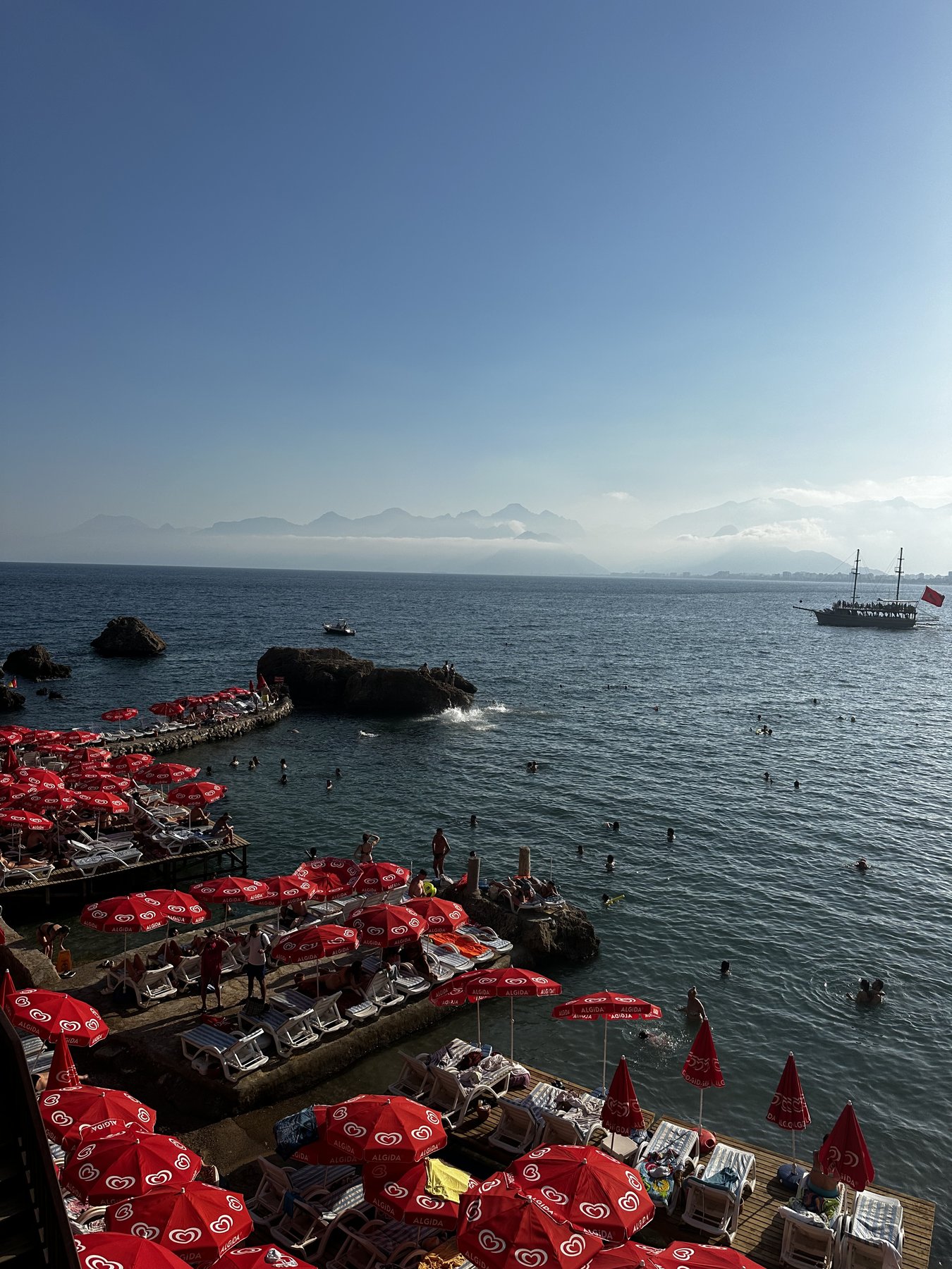red umbrellas along an italian coastal waterfront